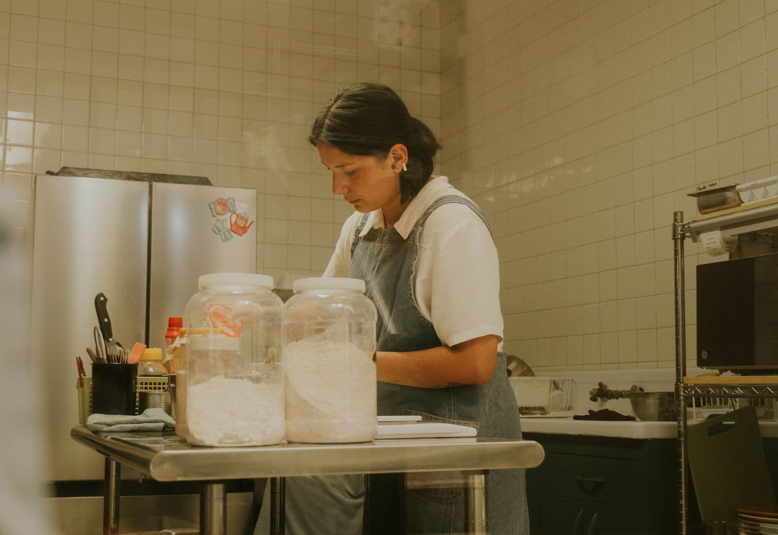 A food entrepreneur preparing ingredients in a commercial kitchen